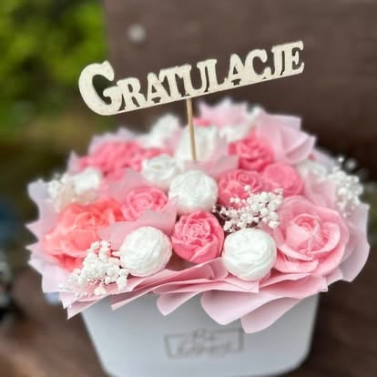 Pink and white floral arrangement in a white box with a Gratulacie congratulations topper